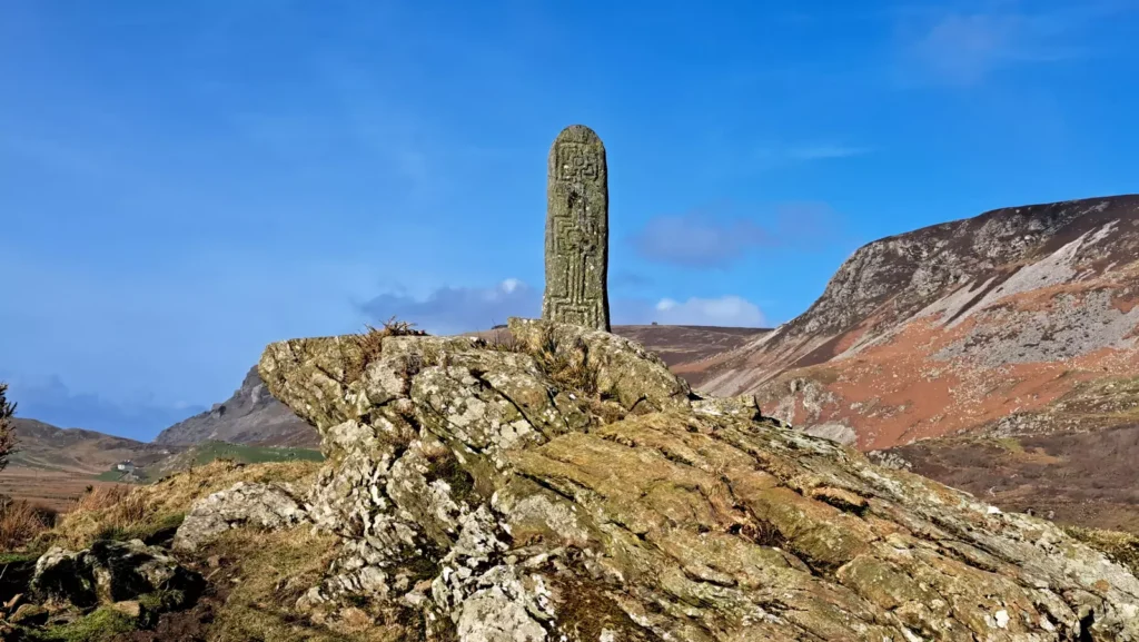 Inscribed historic stone on a rocky hill.