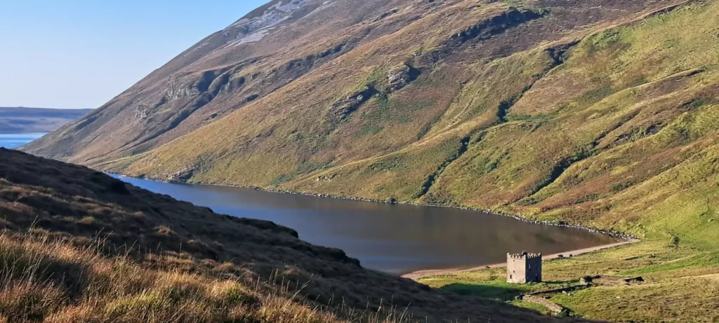 Castle on Lakeshore in remote valley.