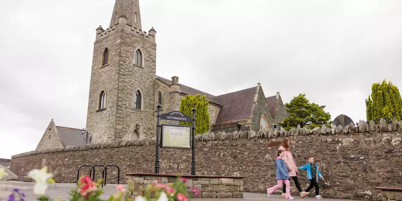 Old church with stone wall surrounding.